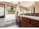 Bright bathroom featuring dual sinks, a soaking tub, and modern fixtures for a spa-like experience at 520 S 196Th Dr, Buckeye, AZ 85326