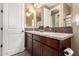 Bathroom vanity with granite countertops, double sinks, dark wood cabinets, mosaic backsplash and neutral paint at 520 S 196Th Dr, Buckeye, AZ 85326