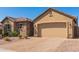 Single-story home with stone accents, a two-car garage, and a paved driveway at 520 S 196Th Dr, Buckeye, AZ 85326