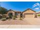 Charming single-story home featuring a stone facade, low-maintenance landscaping, and a two-car garage at 520 S 196Th Dr, Buckeye, AZ 85326