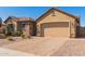 Single-story home with stone accents, a two-car garage, and a paved driveway at 520 S 196Th Dr, Buckeye, AZ 85326