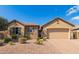 Charming single-story home featuring a stone facade, low-maintenance landscaping, and a two-car garage at 520 S 196Th Dr, Buckeye, AZ 85326