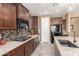 A gourmet kitchen featuring stainless steel appliances, granite counters, and tile backsplash at 520 S 196Th Dr, Buckeye, AZ 85326