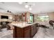 An open concept kitchen with granite countertops, stainless appliances, and views into the breakfast nook at 520 S 196Th Dr, Buckeye, AZ 85326