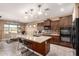 A large kitchen island with granite countertops and dark wood cabinets plus a breakfast nook at 520 S 196Th Dr, Buckeye, AZ 85326