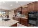 The kitchen has stainless steel appliances, a gas cooktop, granite counters, and a tile backsplash at 520 S 196Th Dr, Buckeye, AZ 85326