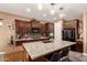 Kitchen with an island, black appliances, granite counters, and tile backsplash at 520 S 196Th Dr, Buckeye, AZ 85326