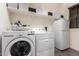 Laundry room featuring LG washer and dryer, storage shelves, and bright white walls at 520 S 196Th Dr, Buckeye, AZ 85326