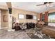 Cozy living room with a ceiling fan, comfortable seating, neutral color scheme, and tile flooring at 520 S 196Th Dr, Buckeye, AZ 85326