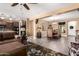 Spacious living room with ceiling fan, comfortable furniture, and an open-concept design to the dining and kitchen area at 520 S 196Th Dr, Buckeye, AZ 85326