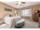 Serene main bedroom with ample natural light, a plush bed, and cozy carpeting for relaxation at 520 S 196Th Dr, Buckeye, AZ 85326