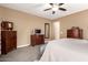 Spacious main bedroom with a dresser, television, neutral tones, and ceiling fan at 520 S 196Th Dr, Buckeye, AZ 85326