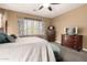 Comfortable main bedroom featuring a queen bed, neutral tones, and blackout curtains at 520 S 196Th Dr, Buckeye, AZ 85326