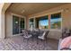 Covered patio with tiled floor, comfortable seating, and view of the backyard at 520 S 196Th Dr, Buckeye, AZ 85326