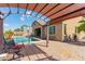 Covered patio overlooking a backyard pool with seating area and outdoor basketball court at 520 S 196Th Dr, Buckeye, AZ 85326