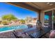 Inviting outdoor space with a sparkling pool, patio seating, and well-maintained landscaping at 520 S 196Th Dr, Buckeye, AZ 85326