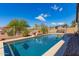 Outdoor pool showcasing water feature, basketball hoop, and covered seating area in backyard at 520 S 196Th Dr, Buckeye, AZ 85326