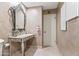 Bathroom featuring a decorative mirror, marble countertop, and tiled floors at 6340 N 34Th Pl, Paradise Valley, AZ 85253
