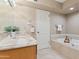 Bathroom featuring marble counters, and a soaking tub with tiled surround at 6340 N 34Th Pl, Paradise Valley, AZ 85253