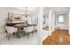 Bright dining room with white walls, wood table, chandelier, and arched doorway detail at 6340 N 34Th Pl, Paradise Valley, AZ 85253