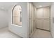 Hallway with arched window and built in storage cabinet at 6340 N 34Th Pl, Paradise Valley, AZ 85253