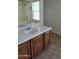 Bathroom featuring a wooden vanity, tile floors, and neutral walls at 6527 W Adams St, Phoenix, AZ 85043