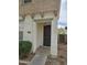 Front door of home featuring concrete walkway and exterior lighting at 6527 W Adams St, Phoenix, AZ 85043
