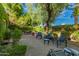 Lush backyard patio with stone pavers, seating area, and mature landscaping at 6701 N Scottsdale Rd # 15, Scottsdale, AZ 85250