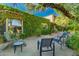Relaxing outdoor patio with lounge chairs and lush greenery in a private backyard setting at 6701 N Scottsdale Rd # 15, Scottsdale, AZ 85250