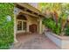Charming entryway with lush greenery, a stone walkway, and a view of the home's entrance at 6701 N Scottsdale Rd # 15, Scottsdale, AZ 85250