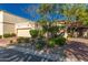 Charming home featuring a two-car garage, desert landscaping, and lovely curb appeal on a sunny day at 6701 N Scottsdale Rd # 15, Scottsdale, AZ 85250