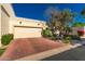 Charming home featuring a two-car garage, desert landscaping, and lovely curb appeal on a sunny day at 6701 N Scottsdale Rd # 15, Scottsdale, AZ 85250