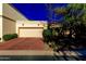 Exterior view of a home with a two-car garage and well-maintained landscaping at 6701 N Scottsdale Rd # 15, Scottsdale, AZ 85250