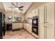 Well-lit kitchen featuring sleek black appliances and ample cabinet space for a modern and efficient cooking experience at 6701 N Scottsdale Rd # 15, Scottsdale, AZ 85250