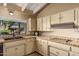 A close up view of the kitchen sink and stove with terracotta tile countertops at 6701 N Scottsdale Rd # 15, Scottsdale, AZ 85250
