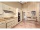View of a charming kitchen featuring light-yellow cabinets, terracotta tile floors, and modern appliances at 6701 N Scottsdale Rd # 15, Scottsdale, AZ 85250