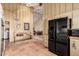 The kitchen features terracotta tile floors, wooden bench, and stainless-steel refrigerator at 6701 N Scottsdale Rd # 15, Scottsdale, AZ 85250