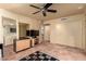 Cozy living room with a ceiling fan, built-in shelving, and a television stand, perfect for relaxing at 6701 N Scottsdale Rd # 15, Scottsdale, AZ 85250