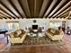 Inviting living room features sofas, terracotta floors, beamed ceilings, and fireplace at 6701 N Scottsdale Rd # 15, Scottsdale, AZ 85250