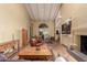 Bright living room with beam ceilings, fireplace, seamlessly connected to the dining area, creating an inviting space at 6701 N Scottsdale Rd # 15, Scottsdale, AZ 85250