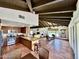 Open-concept living space with terracotta floors and beamed ceilings at 6701 N Scottsdale Rd # 15, Scottsdale, AZ 85250