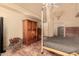 The main bedroom boasts terracotta tile floors, an antique armoire, and a ceiling fan at 6701 N Scottsdale Rd # 15, Scottsdale, AZ 85250