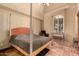 The main bedroom features terracotta tile floors, large windows and a four-poster bed at 6701 N Scottsdale Rd # 15, Scottsdale, AZ 85250