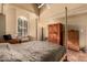 The bright main bedroom features terracotta tile floors, windows with lots of natural light and high ceilings at 6701 N Scottsdale Rd # 15, Scottsdale, AZ 85250