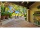 Inviting outdoor patio with comfortable seating, lush plants, and a pergola for shade at 6701 N Scottsdale Rd # 15, Scottsdale, AZ 85250