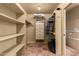 Spacious walk-in closet featuring ample shelving, hanging rods, and built-in drawers for organized storage at 6701 N Scottsdale Rd # 15, Scottsdale, AZ 85250