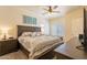 Spacious bedroom with a comfortable bed, soft lighting, and a ceiling fan at 7401 W Arrowhead Clubhouse Dr # 2003, Glendale, AZ 85308