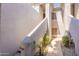 Sunlit courtyard featuring textured walls, a skylight, and desert landscaping creates an inviting and private outdoor space at 7401 W Arrowhead Clubhouse Dr # 2003, Glendale, AZ 85308