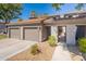 Charming single-story home showcasing well-maintained landscaping, complemented by a two-car garage and inviting entryway at 7401 W Arrowhead Clubhouse Dr # 2003, Glendale, AZ 85308