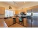 Bright kitchen with stainless steel appliances, light wood cabinetry, and functional layout at 7401 W Arrowhead Clubhouse Dr # 2003, Glendale, AZ 85308